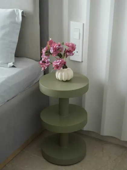 This olive-green side table offers a modern, kid-friendly design with rounded edges for safety and tiered shelves for storage. Its sturdy cylindrical build and compact size make it both functional and stylish.