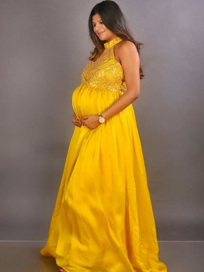 We also offer non-maternity gowns for pre-wedding shoots and other events. This hand-embroidered yellow satin gown is a vibrant and flowy option for any celebration.