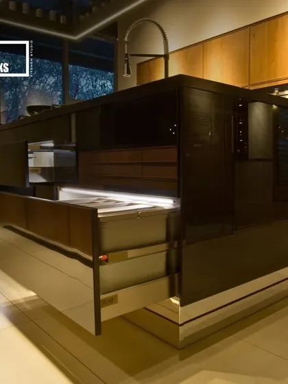 A showcase of a fully-equipped kitchen island with multiple layers of drawers, all featuring integrated lighting for better visibility.