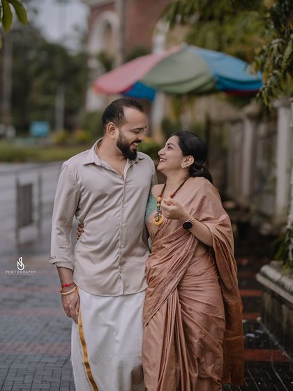 A romantic walk on a rainy day. The wet pavement creates beautiful reflections and adds to the moody atmosphere.