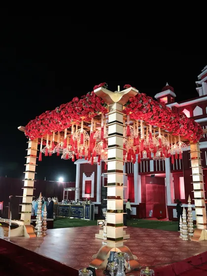 The centerpiece of the royal wedding was this magnificent mandap, heavily adorned with red roses and traditional hanging 'kaleeras', creating a stunning focal point.