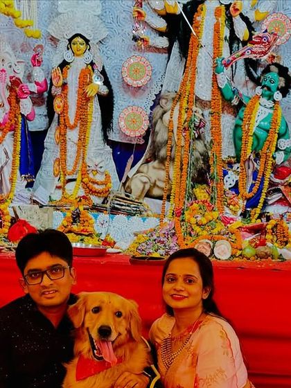 A happy family poses with their Golden Retriever, Roger, at the Durga Puja event. Moments like these are why we create spaces where no family member is left behind.