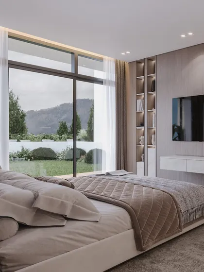 A view from the bed showcasing the stunning mountain landscape, demonstrating how the architecture frames the natural beauty outside.