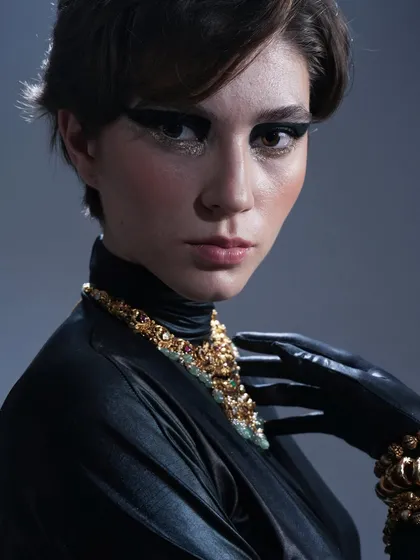 For this fashion editorial, the goal was a powerful and chic look. I created a bold, black graphic winged liner with a touch of gold glitter underneath to catch the light.