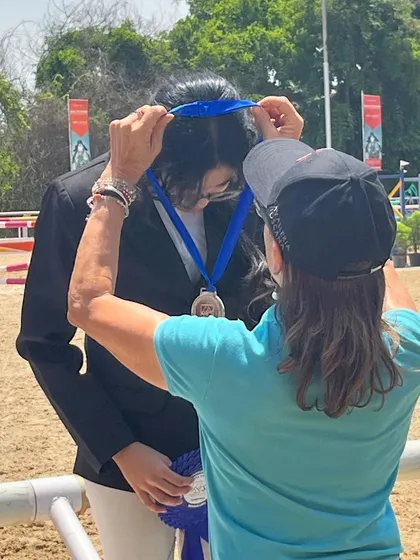 A close-up of a rider being awarded her medal. This is the moment where all the hard work, sweat, and dedication pays off.