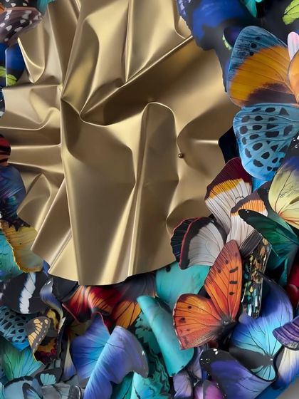 A detail of the golden, crumpled steel at the heart of the "Metamorphosis in Metal" installation.