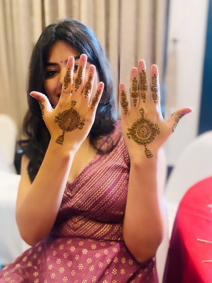 A client showing off her simple yet elegant party mehndi. The hanging mandala design is a popular and timeless choice for guests.