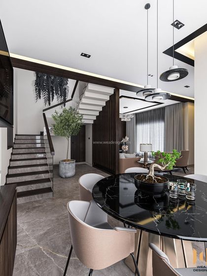 A view from the dining table looking back towards the living area and staircase, highlighting the open and interconnected layout.