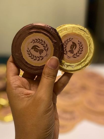 Custom-branded chocolate coins for the Gladia launch event. We can create personalized edibles to match any event theme or corporate branding.
