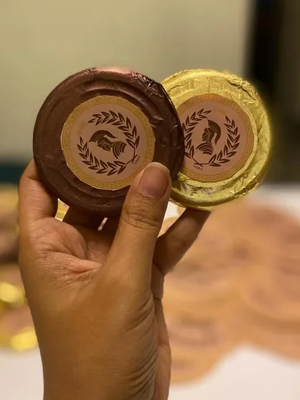 Even the chocolates were on-theme. These custom-branded chocolate coins were a small but delightful detail in our Roman-themed hampers for the Gladia launch.