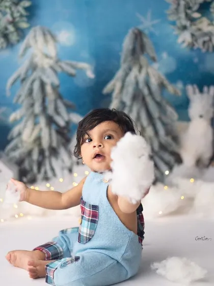 Cuteness has just been overloaded. This little one is having so much fun playing with the "snow" in this magical winter-themed sitter session.
