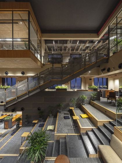 At night, the Primarc office transforms. The lighting design highlights the architectural volumes and the terraced seating, creating a dramatic and inspiring atmosphere that supports after-hours work and company events.