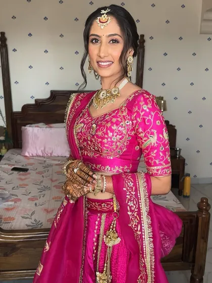 Capturing the pure joy of a pre-wedding function. This look is all about a radiant, soft-focus base, a golden glow, and flushed cheeks that match the bride's vibrant smile and energy.