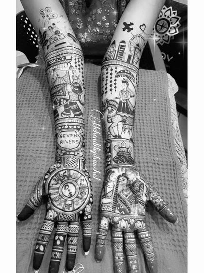 A black and white view of the storytelling mehendi, highlighting the intricate line work of the city skyline, family portraits, and traditional patterns.
