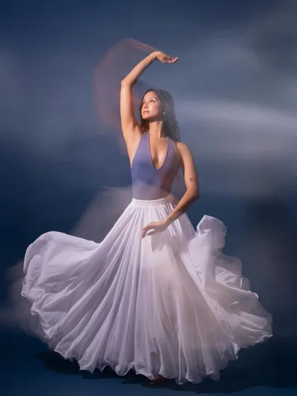 The swirl of a white skirt captured with a slow shutter speed. I work with photographers to experiment with different techniques to best capture the essence of dance.