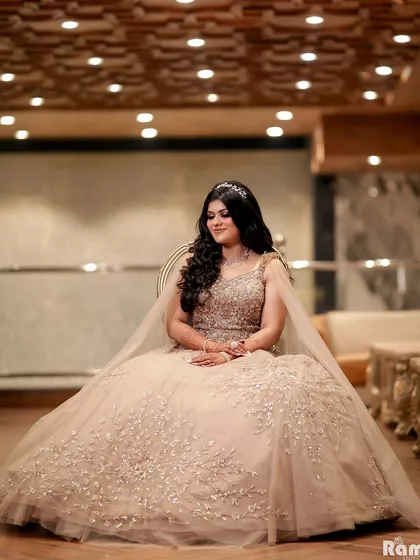 A beautiful solo portrait of the bride-to-be on her engagement day. Seated like royalty, her magnificent gown and serene expression create a picture of pure elegance.