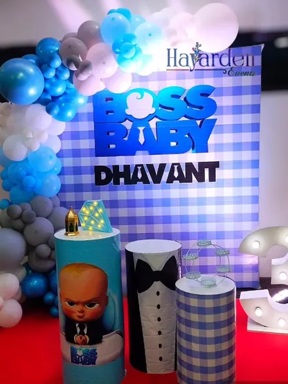 This Boss Baby setup uses a blue gingham backdrop and a large 3D 'Boss Baby' sign. The marquee number '3' and character-wrapped plinth complete the look for the little boss.