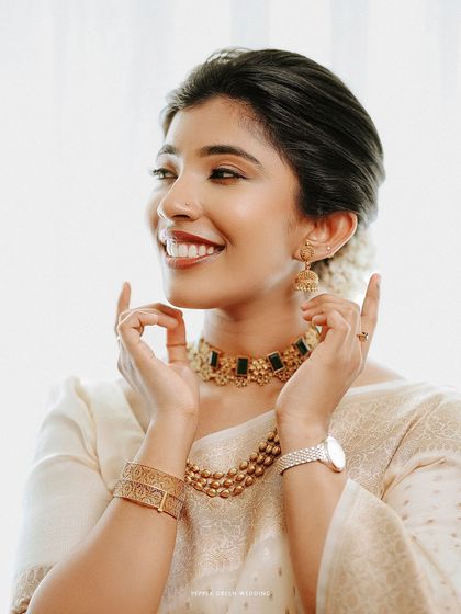 A close-up of the bride's joyful expression, highlighting her beautiful smile and elegant jewelry.