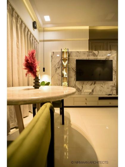 A view across the dining table to the TV unit in this modern classic home. The layout ensures that the dining and living areas feel connected, yet have their own distinct zones.