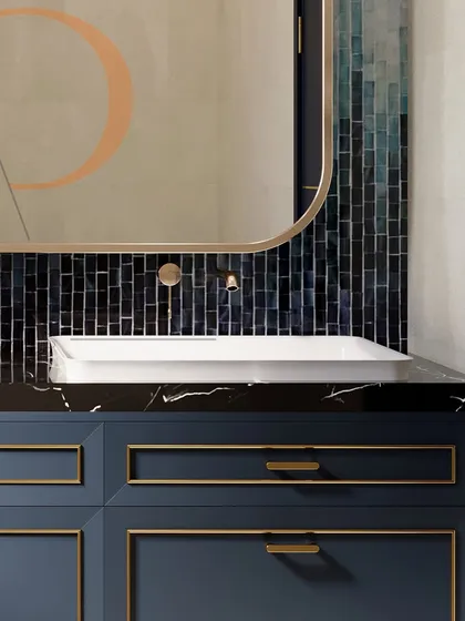 A detail shot of the white vessel sink on the black marble countertop, highlighting the contrast and the fine craftsmanship of the vanity.