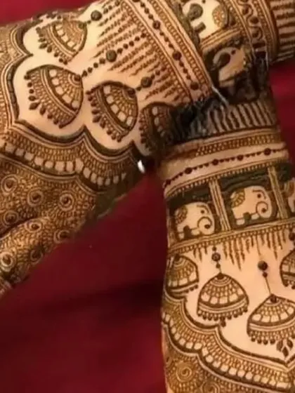A playful and traditional design featuring jhumka (earring) and elephant motifs. The patterns are dense and intricate, perfect for a bride who loves classic symbols.