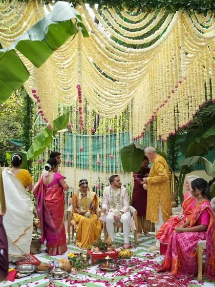 An intimate wedding ceremony doesn't mean compromising on beauty. This mandap, created with curtains of fragrant tuberose and framed by lush banana leaves, was designed to feel both sacred and deeply personal for a beautiful South Indian wedding.