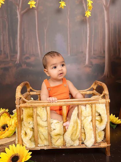 Another perspective of the enchanted forest theme, showing the baby looking curiously at the hanging yellow flowers. I use different props and angles to provide a variety of shots.