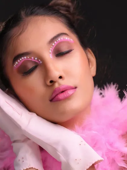 Eyes closed to showcase the full detail of the eye makeup.