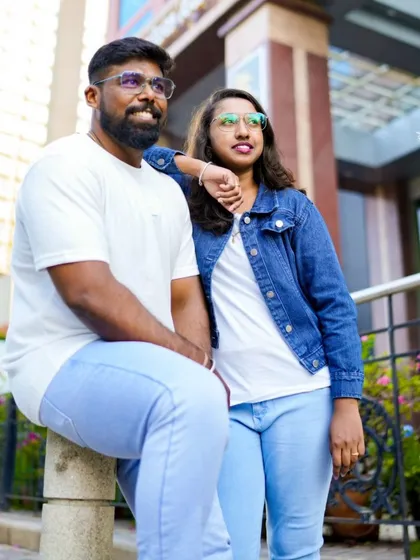 A relaxed portrait of the couple in a city setting. Their casual denim and white outfits are perfect for an urban pre-wedding shoot.