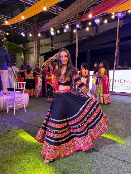 Feeling the festive lights and music at a Navratri night event. My personal style is a mix of traditional grace and modern energy.