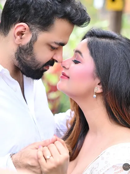 A soft, romantic close-up from a pre-wedding session. The warm lighting and gentle interaction between the couple create a dreamy and intimate atmosphere.