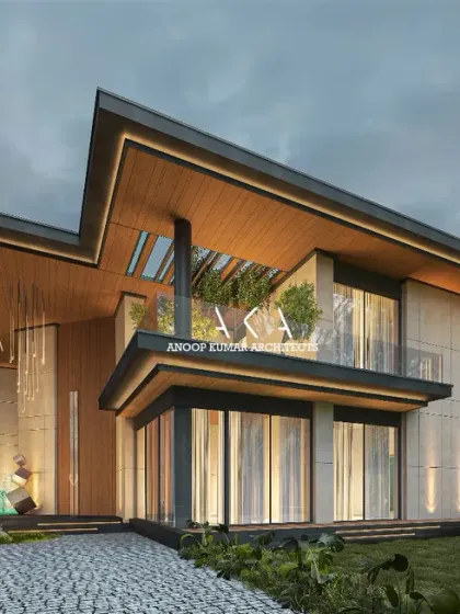 This farmhouse design incorporates natural elements with its use of light-toned stone and wood-paneled ceilings. The large windows and open balcony are designed to maximize views and natural light.