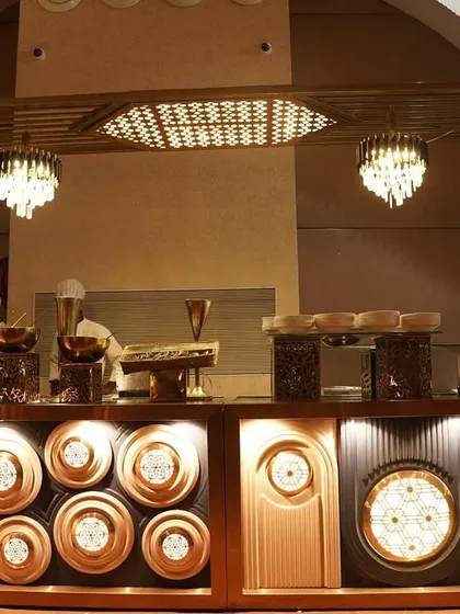 This is an example of one of my grand buffet setups. I focus on creating an artistic and inviting display with custom lighting and elegant serveware, making the food counter a true centerpiece of the event.