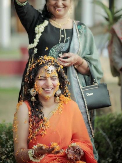 A fun and joyful moment from a haldi ceremony. The bride's hands, decorated with my mehendi, add to the festive spirit.