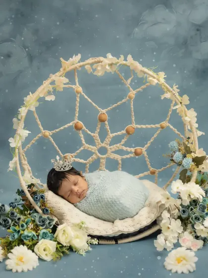 A close-up of this little princess, peacefully asleep in her floral dreamcatcher swing. Every detail is set up to create a magical newborn photo.