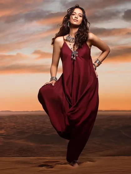 A duplicate of image 17, this portrait captures the essence of our desert shoot, with styling that includes a flowing maroon outfit and bold, ethnic-inspired jewelry.