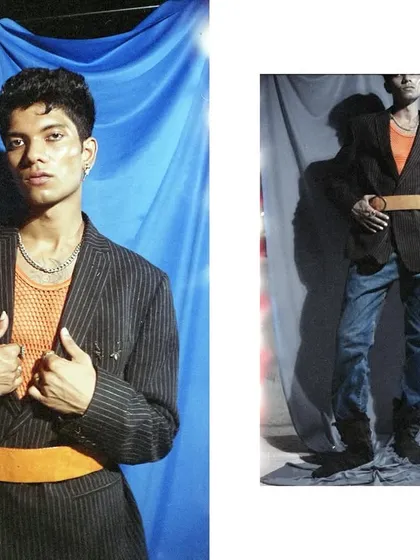 A close-up portrait from the blue backdrop series, captured on film. The model's direct eye contact and the rich colors of the orange shirt and yellow belt are prominent.