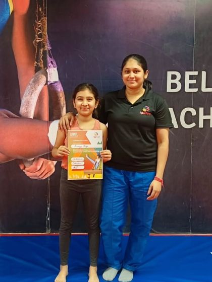 A happy student poses with her coach after receiving her "JUMP" program certificate.