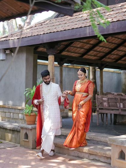The couple making their way through the traditional venue, hand in hand. A candid moment that feels both grand and intimate.