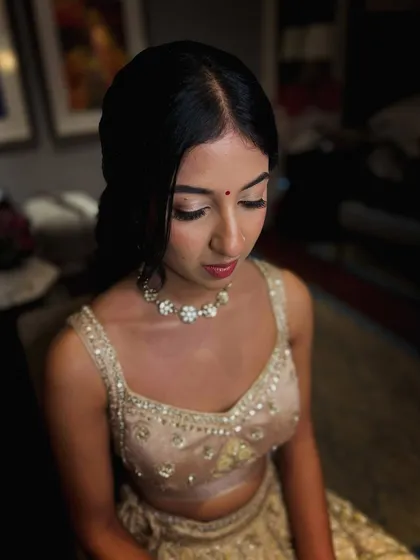 A close-up of the bride's subtle makeup, her skin glowing and her expression serene.