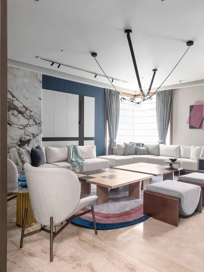 A full view of the modern loft living area, highlighting the unique circular rug and contemporary furniture. The design plays with color and texture to bring a subtle charm to the ambiance.