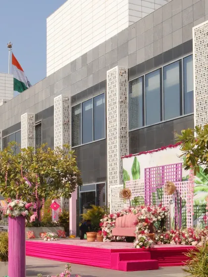 A daytime Haldi ceremony by the pool, designed with a fresh and modern aesthetic. We used a vibrant pink color scheme for the stage and seating, complemented by lush floral arrangements and contemporary decor elements, creating a chic and joyful celebration space.