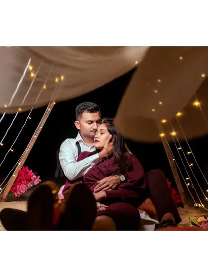 An intimate and cozy pre-wedding photo of a couple inside a beautifully lit tent, perfect for a romantic and stylized shoot.