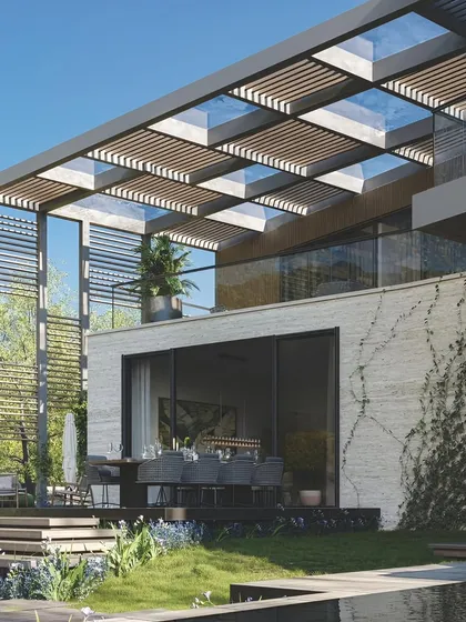 This multi-level architectural project features one of our integrated glass and louvered pergolas. The design provides shade for the upper balcony and lower dining area, demonstrating how our structures can be a core element of a home's modern facade.