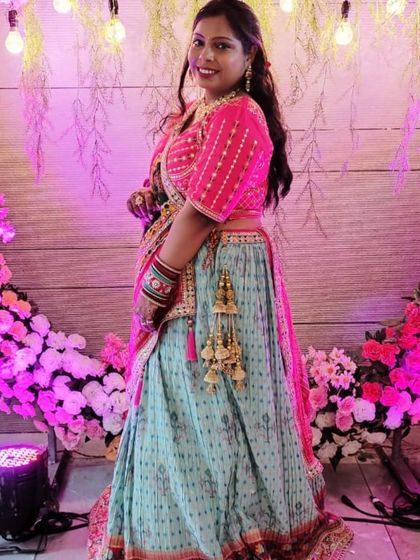Another shot of the client in the colorful printed lehenga, posing happily.