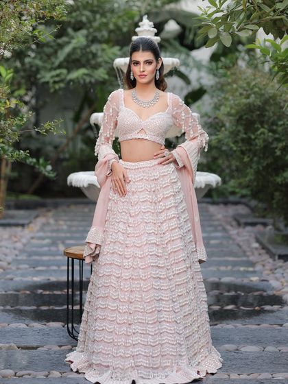 A full shot of this modern bride in her stunning pink and white lehenga. The makeup is kept soft and romantic to match the dreamy vibe.