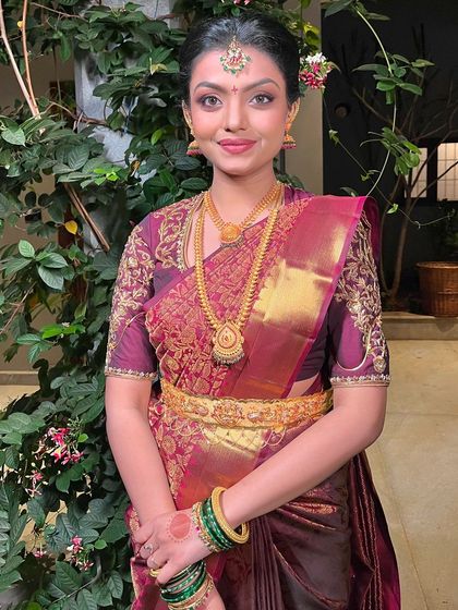A portrait of a beautiful bride with a classic bun, ready for her muhurtham.