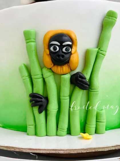 Monkey from Kung Fu Panda peeking through the bamboo. Creating side details adds depth and fun to the cake.