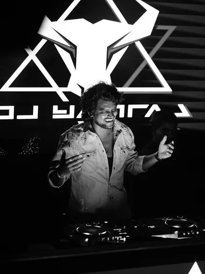A black and white shot from a Women's Day bash, capturing a moment of pure joy behind the decks.