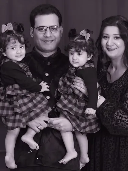 A black and white version of the twin family portrait. Monochrome can add a timeless, artistic quality, focusing purely on expression and emotion.